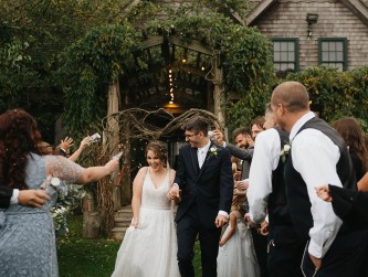 Emily and Zack kiss exiting barn - photo by Thalia Abreu @thaliacamerist